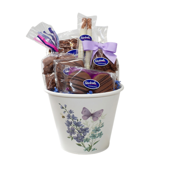 Gift basket with Peterboro chocolate bars in a decorative container on a white background