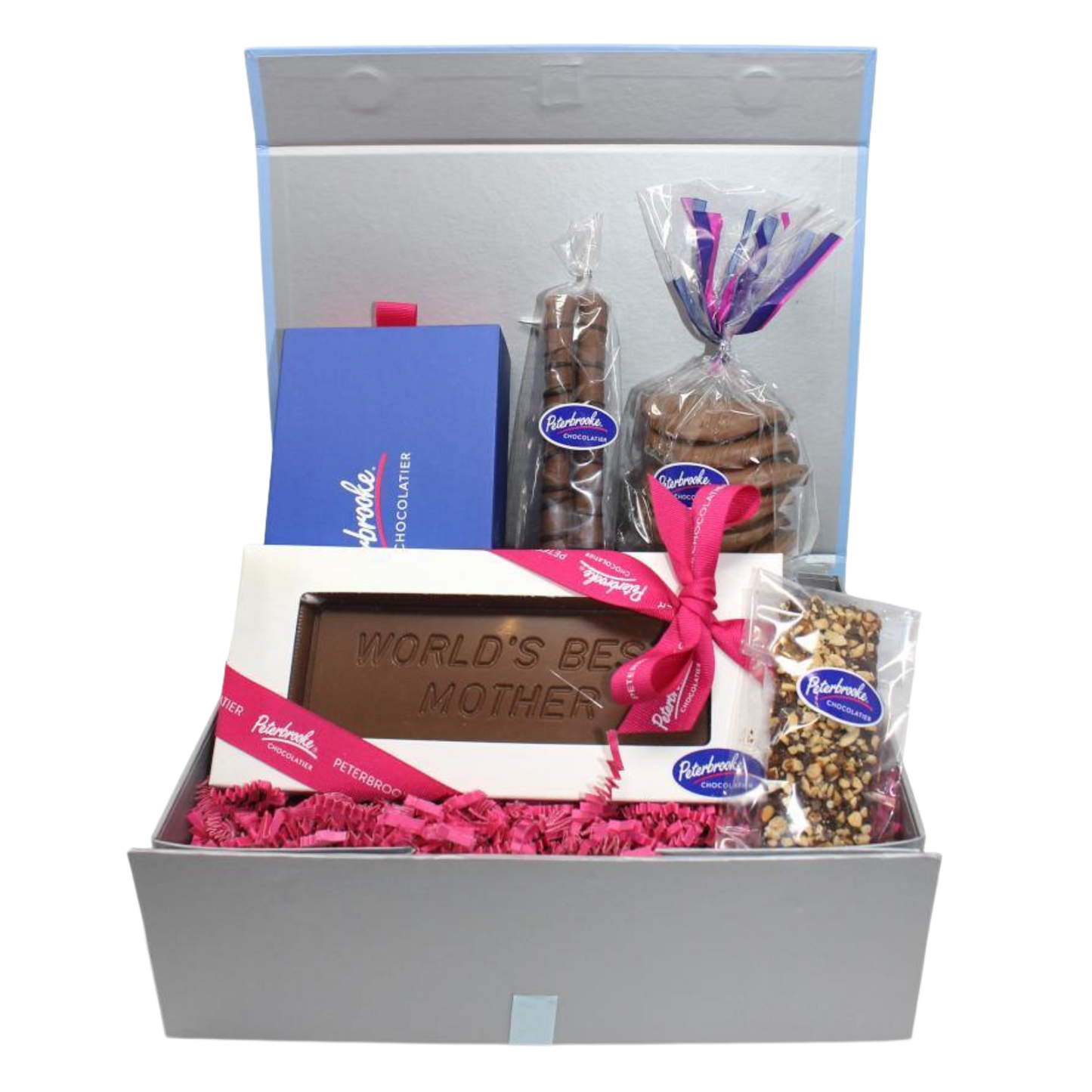 Gift basket with chocolate bar, cookies, and other treats in a box on a white background