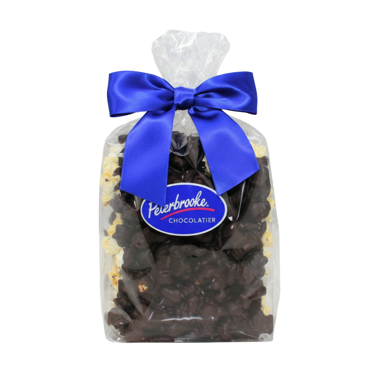 A clear gift bag containing two 6 oz bars of Dark Chocolate Covered Popcorn Duo, tied with a shiny blue ribbon. The front label reads Fisherbrooke Chocolatier.