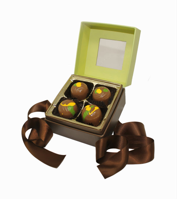 Open box of Dubai chocolate truffles with a brown ribbon on a white background