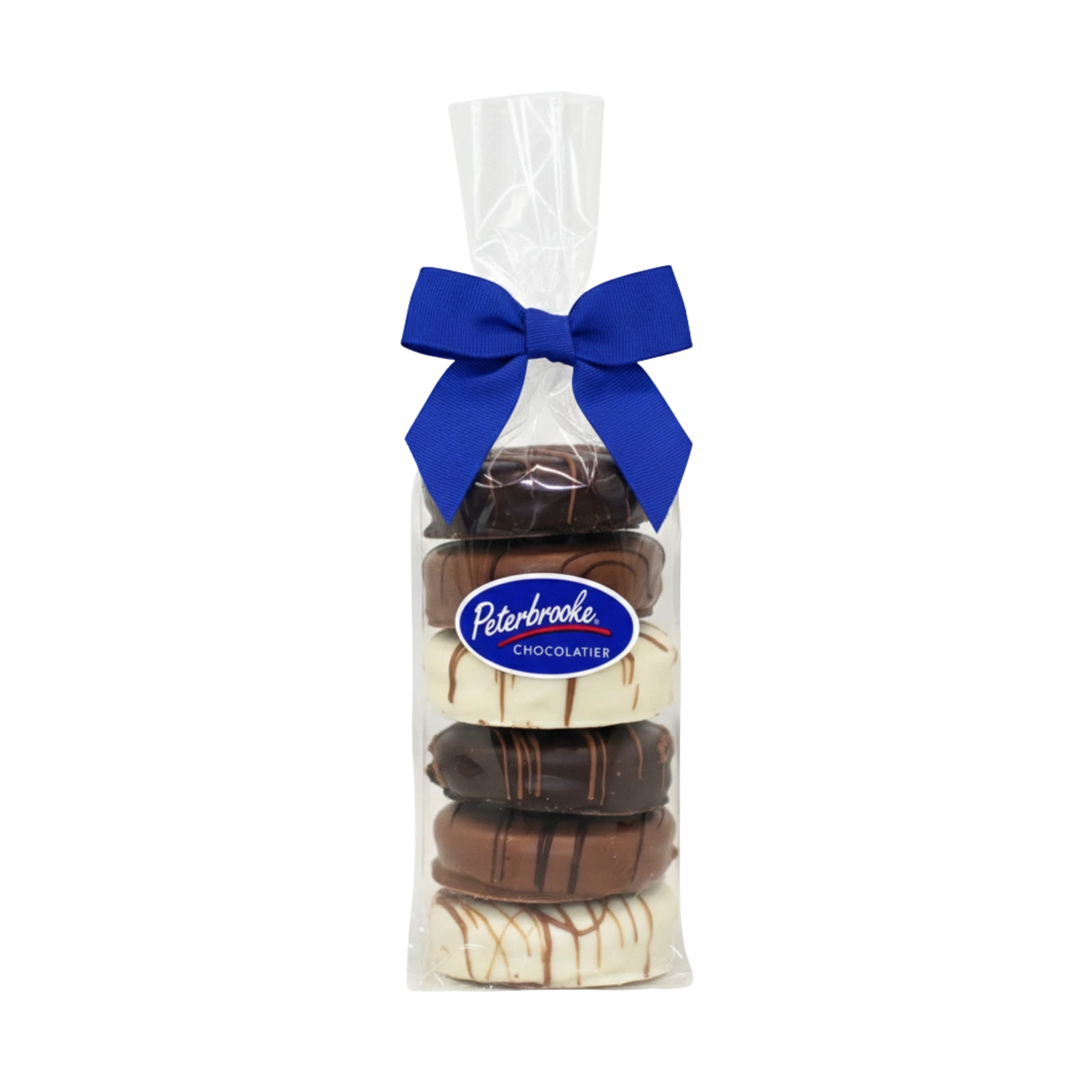 A clear gift bag with a light gray bow holds a Hand-Dipped Chocolate Covered Oreos – 6 Pack (milk, dark & white chocolate), finished with a blue Peterbrooke Chocolatier label—an elegant, handmade gift.