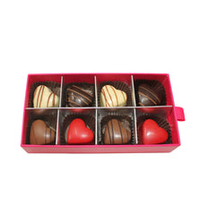 Box of chocolates with heart-shaped candies on a white background