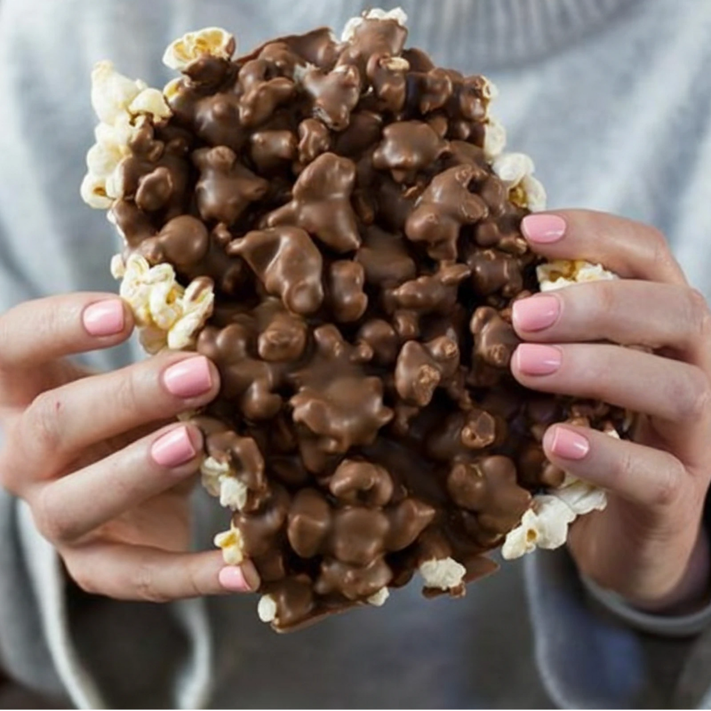 Holding chocolate Covered Popcorn Bar